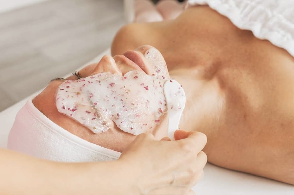 Een rubberachtig hydrojelly masker wordt in één vel van een gezicht af getild.