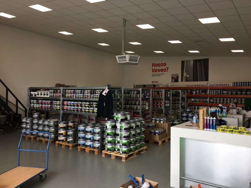 Overzicht van verfblikken en materialen in de Veveo-winkel